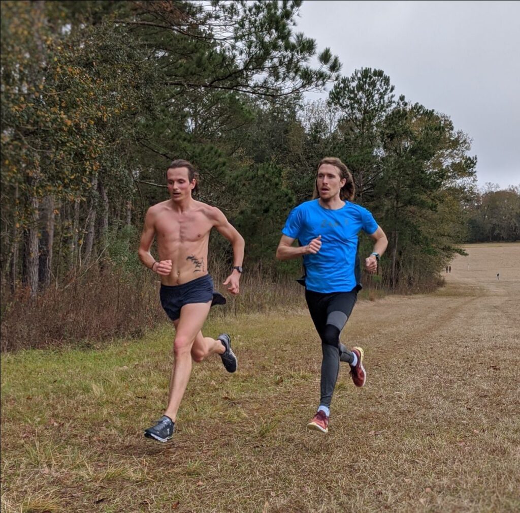 Joe and Andrew run uphill strides during half marathon training.